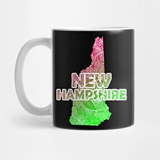 Colorful mandala art map of New Hampshire with text in pink and green Mug